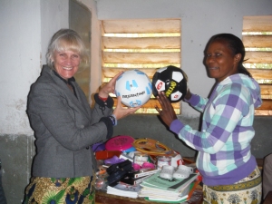 WOFAD volunteer Sophie Belanger makes a donation to the school and child care center in Machinjiri
